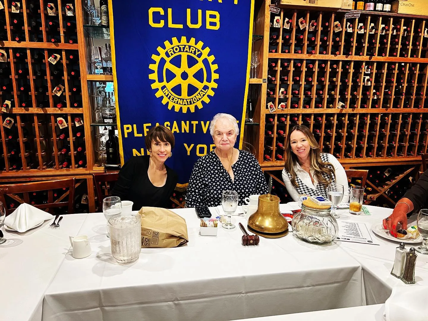 Margaret Cunzio, Helen Grishman and Natasha Ginsburg Shishov at the club banner