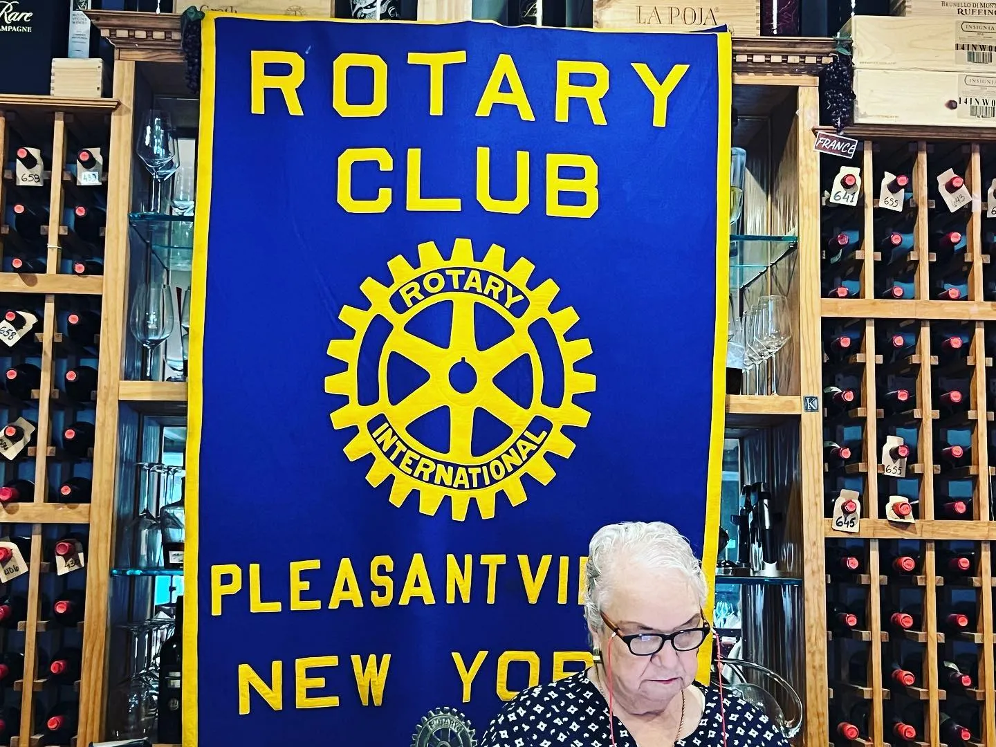 Helen Grishman working at the club banner during a Thursday lunch meeting