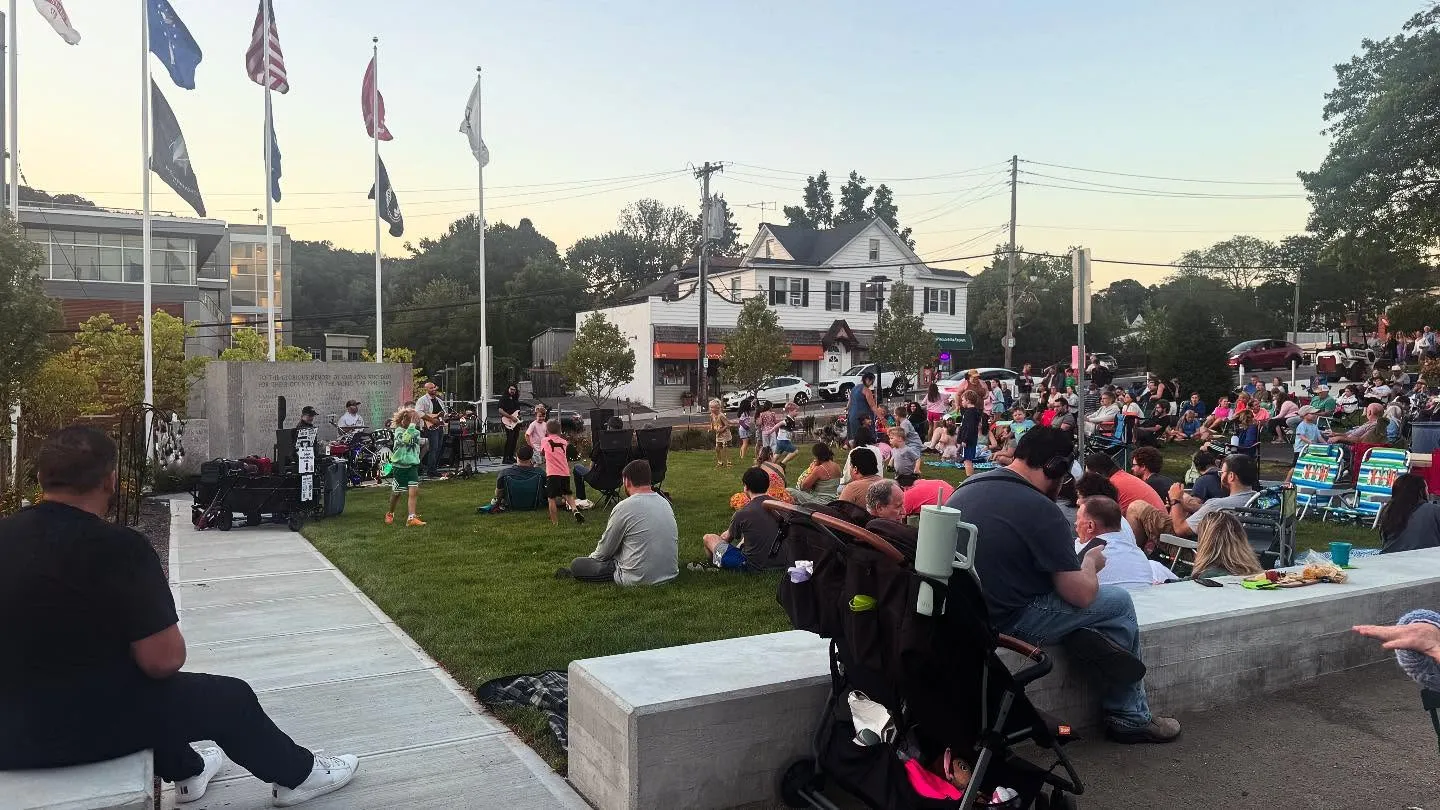 Neighbors gathered on the village green on a summer evening