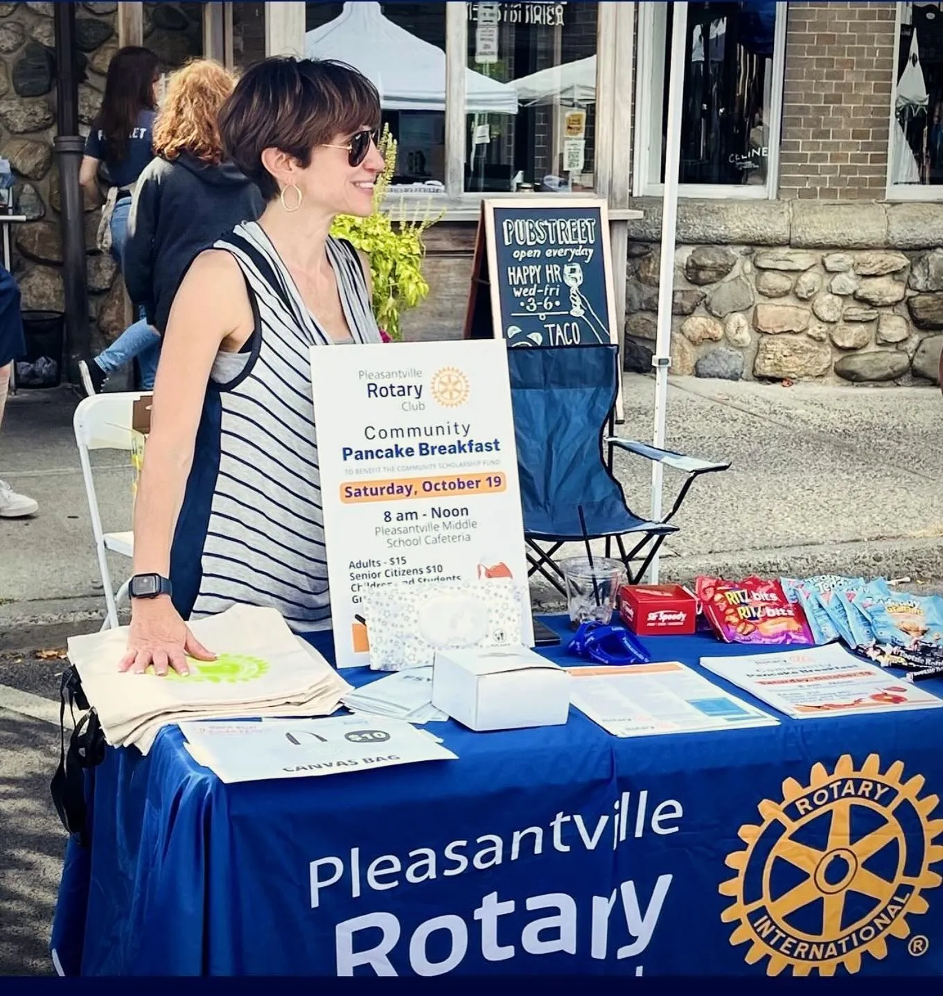 Margaret Cunzio at the Rotary table at the Pleasantville block party