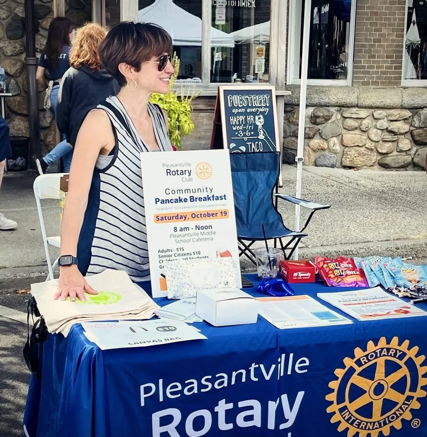 Margaret Cunzio at the Rotary table at the Pleasantville block party