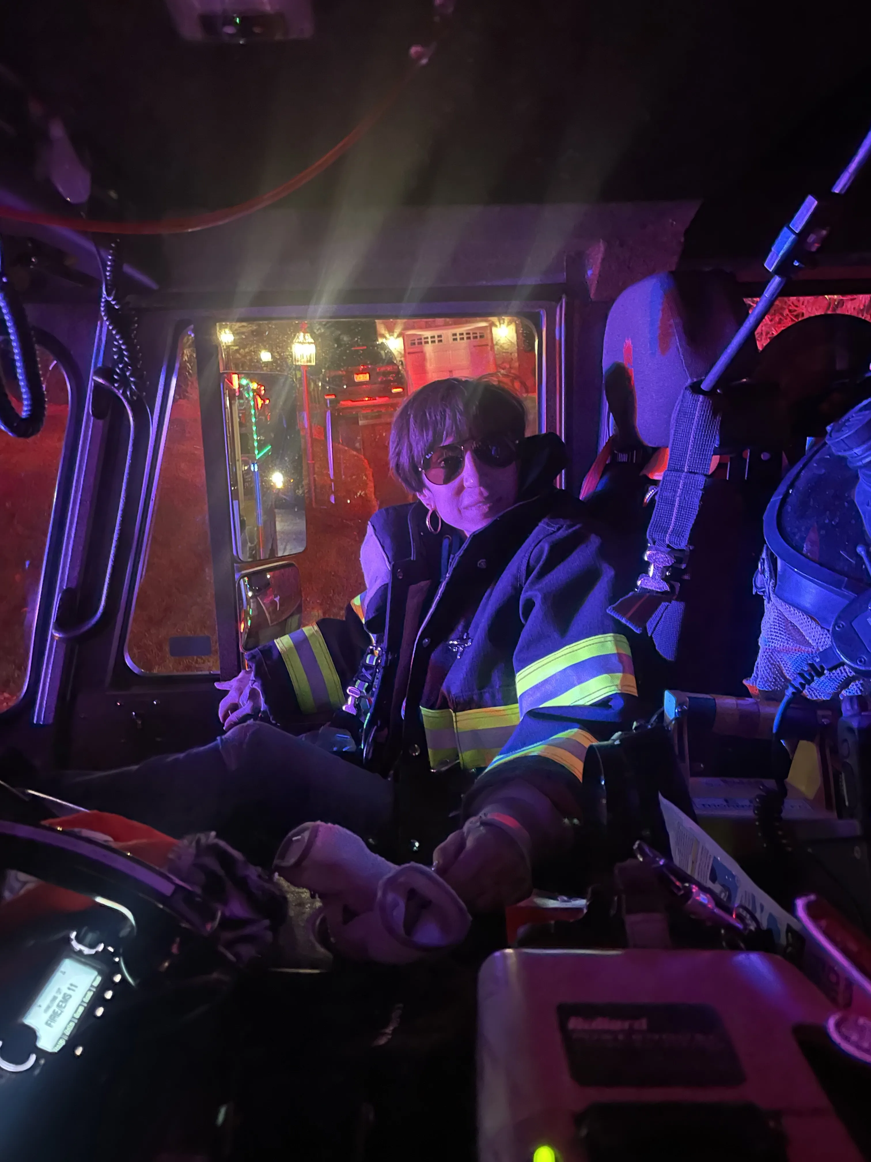 Margaret in the cab of a fire engine at night