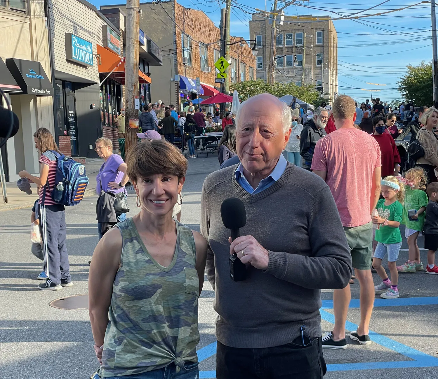Margaret with an interviewer on Wheeler Avenue during the street fair