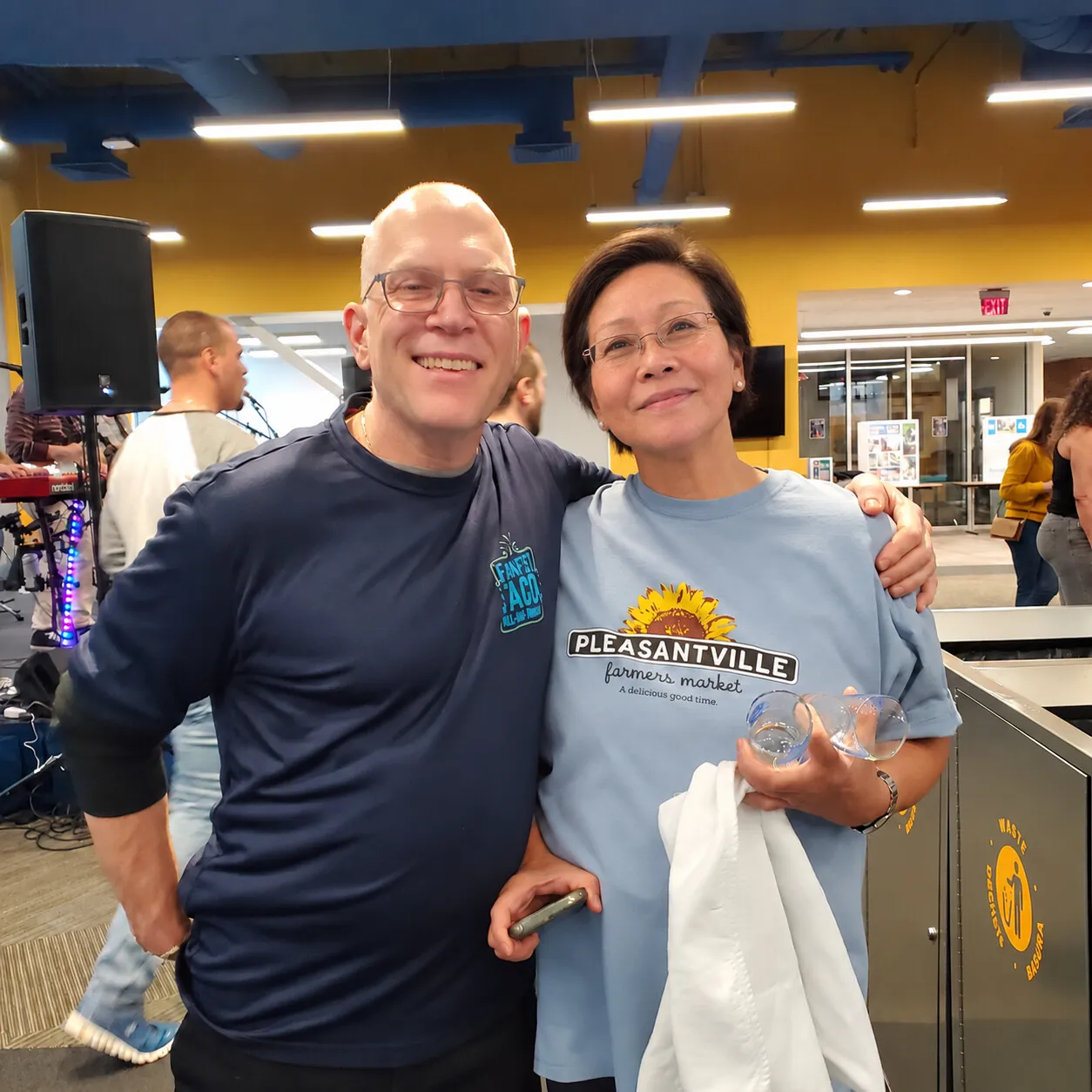 Marlene Canapi in a Pleasantville Farmers Market shirt with a fellow volunteer at the spring tasting