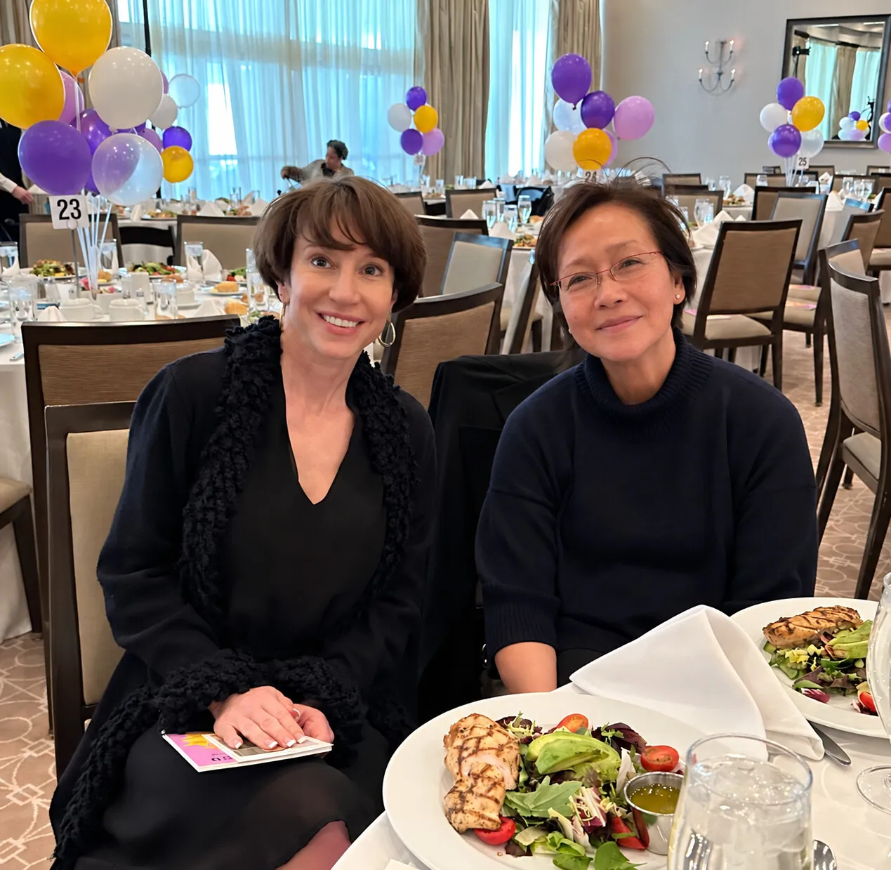 Marlene Canapi and Margaret Cunzio seated at a luncheon table