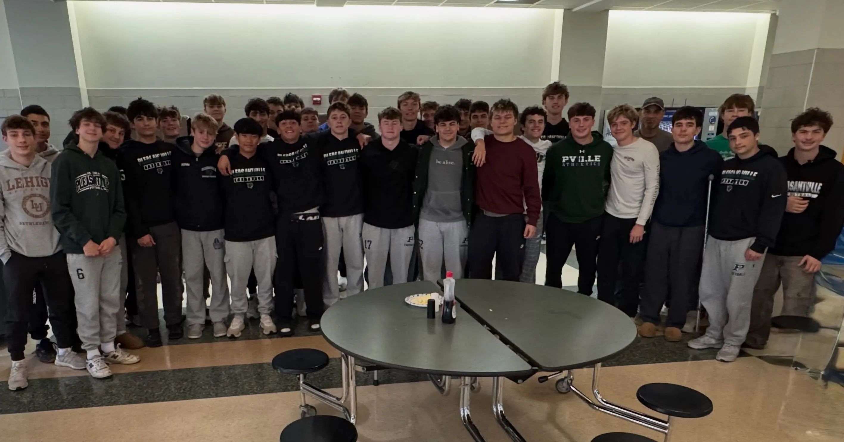 Pleasantville High School football players eating breakfast together