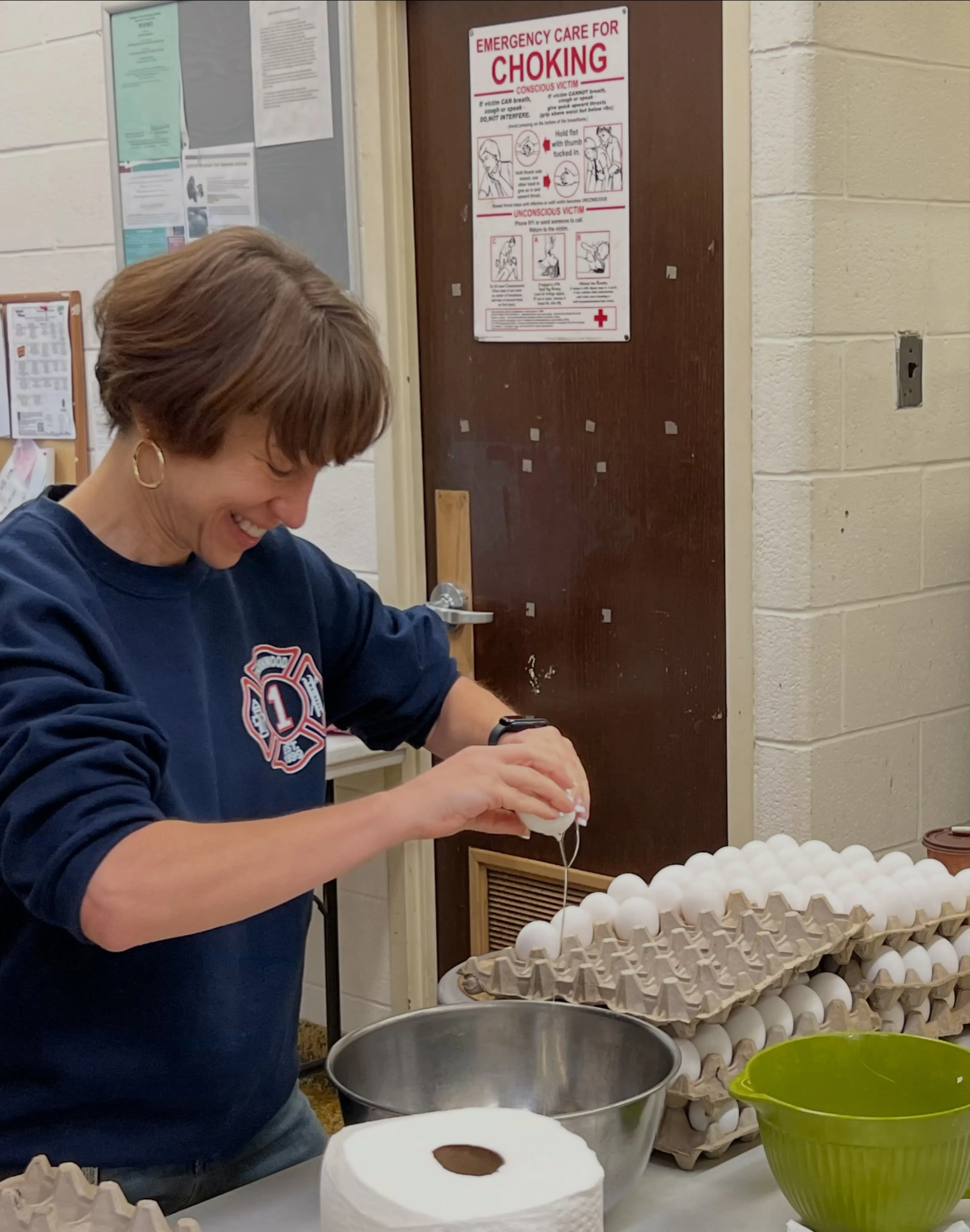 Margaret Cunzio cracking eggs in the school kitchen